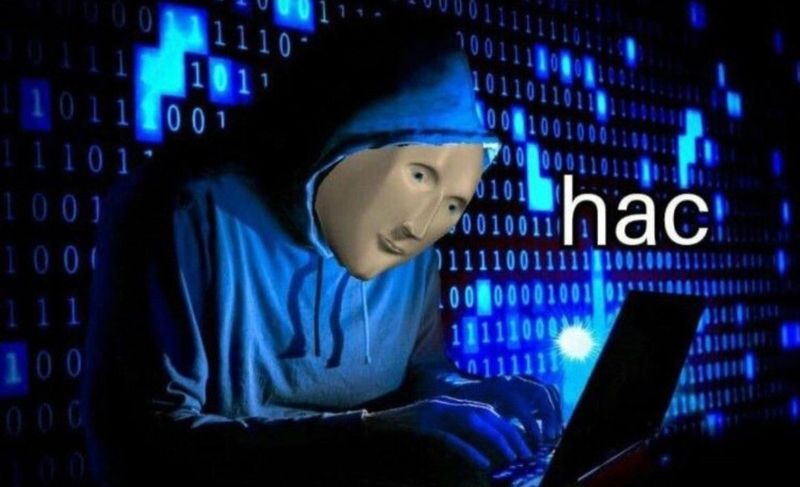Meme of a hooded figure typing on a laptop in front of streams of blue binary code, captioned hac
